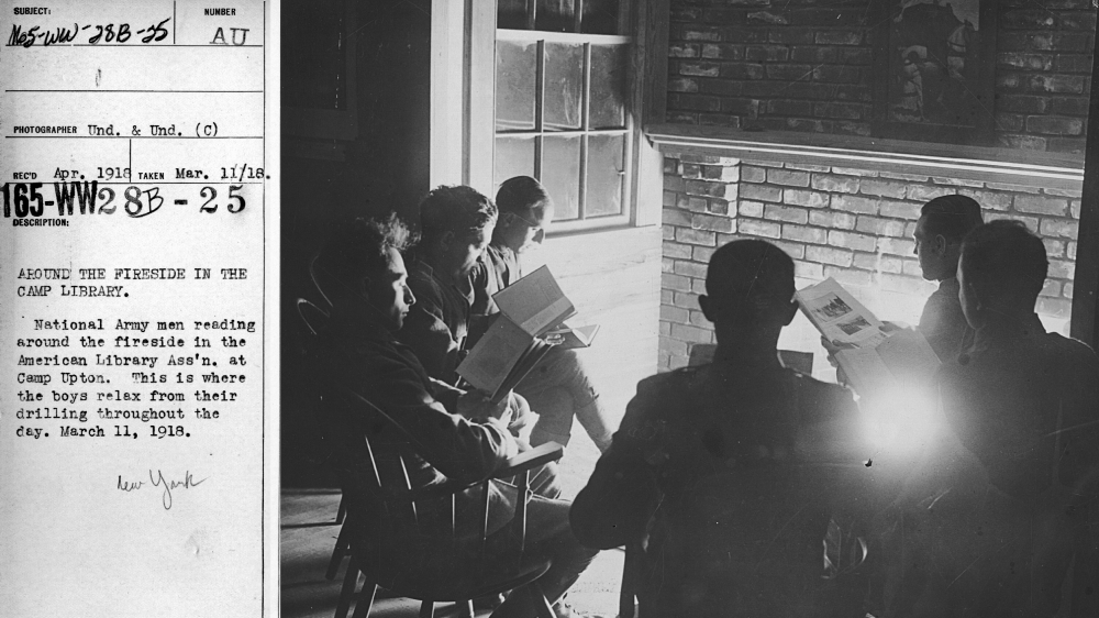 National Army men reading around the fireside in the American Library Association at Camp Upton, March 11, 1918, from the US National Archives